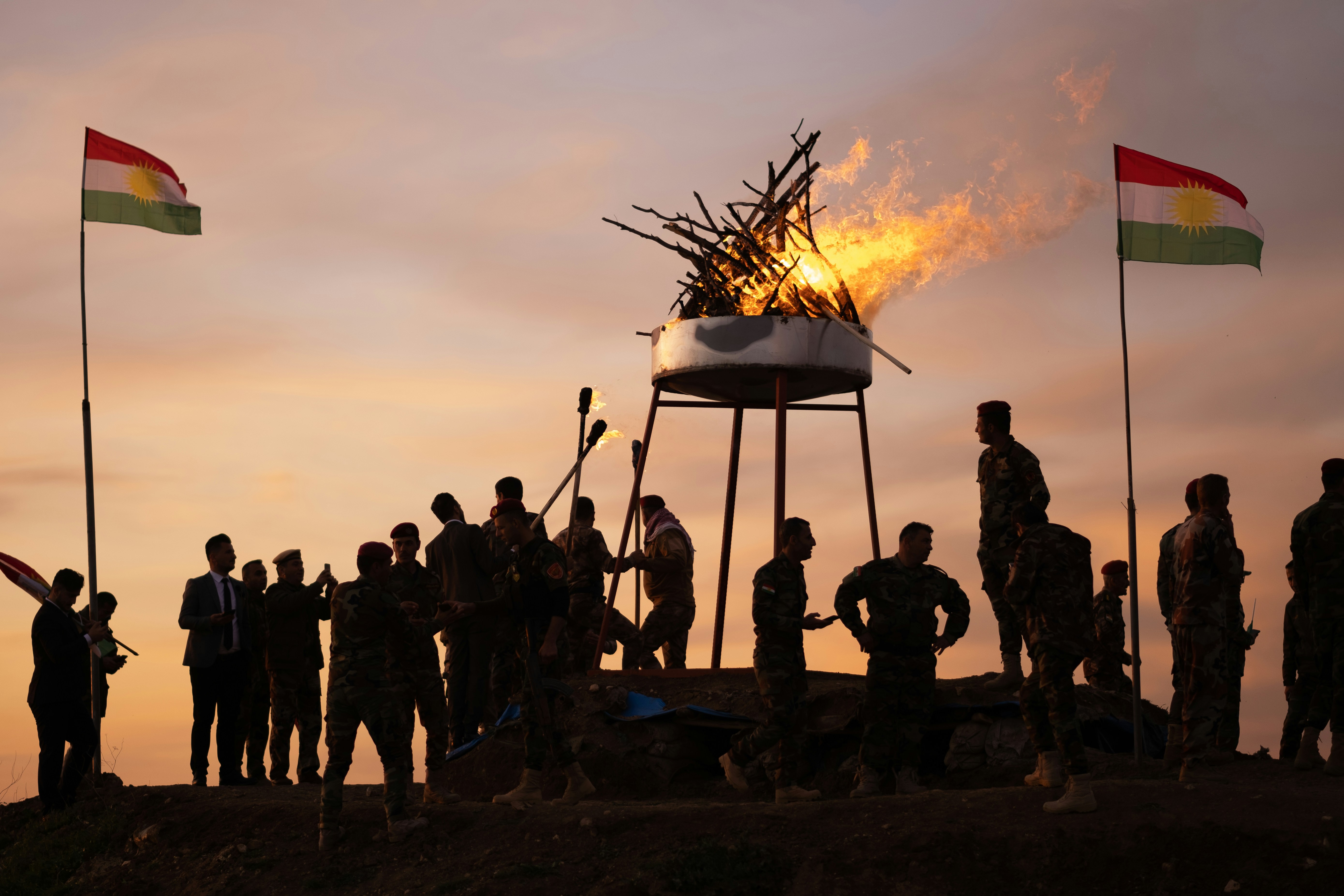 Newroz celebrations with Kurdish flags and a ceremonial fire