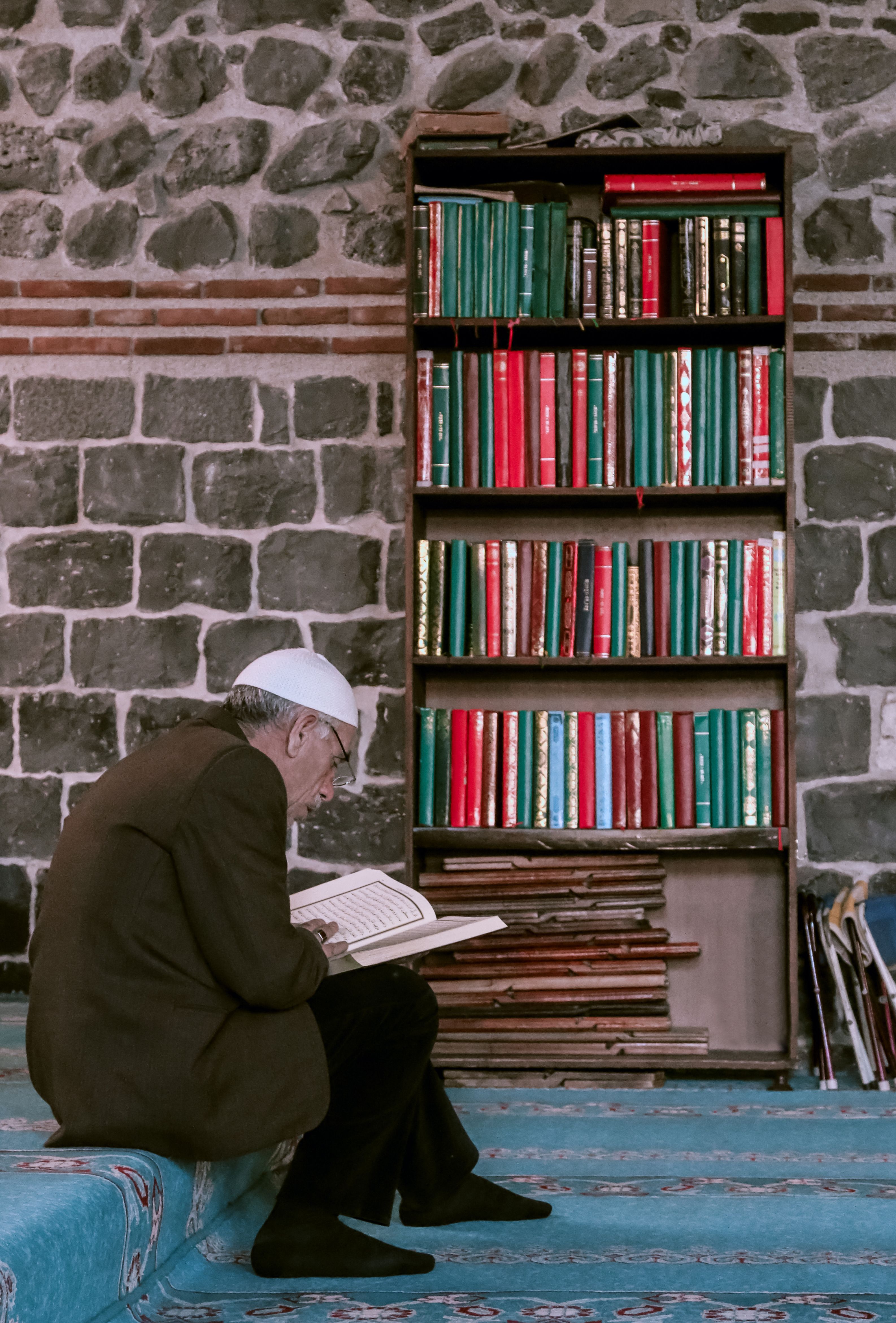 A reader studying a religious text inside a historic mosque